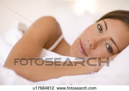 Stock Image - Woman in bed. Fotosearch