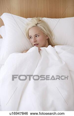 Stock Photograph - Woman in bed. Fotosearch