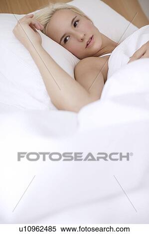 Stock Photography - Woman in bed. Fotosearch