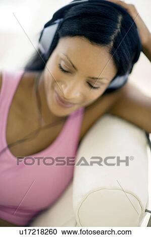 Woman listening to music View Large Photo Image Stock Image - Woman listening to music. Fotosearch