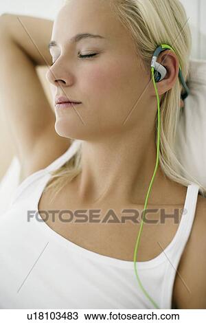Woman listening to music View Large Photo Image Stock Image - Woman listening to music. Fotosearch