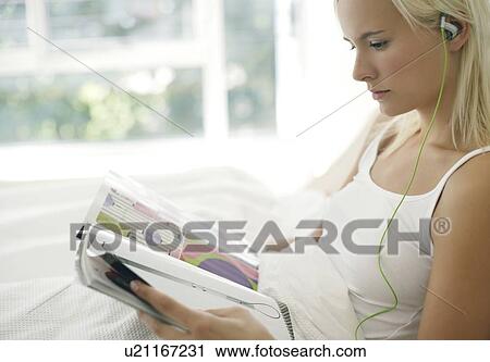 Woman listening to music View Large Photo Image Stock Image - Woman listening to music. Fotosearch