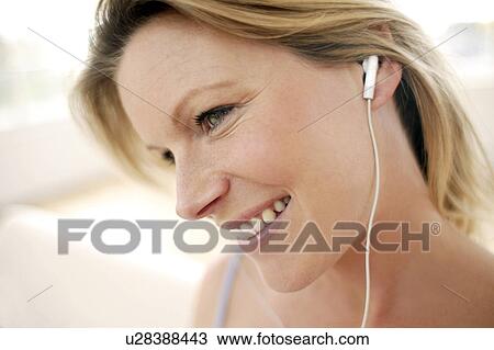 Stock Image - Woman listening to music. Fotosearch