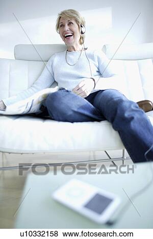 Stock Photo - Woman listening to music. Fotosearch