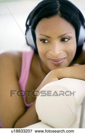 Woman listening to music View Large Photo Image Stock Photo - Woman listening to music. Fotosearch
