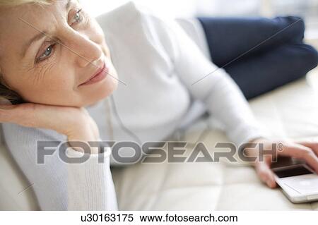 Woman listening to music View Large Photo Image Stock Photography - Woman listening to music. Fotosearch