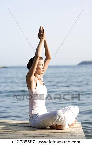 Stock Photo - Woman performing yoga exercise. Fotosearch