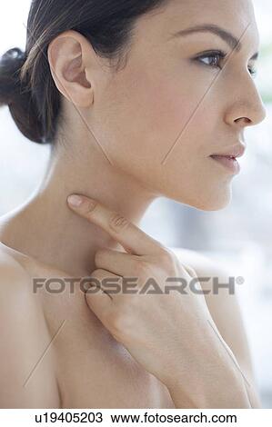 Stock Image - Woman pointing to mole. Fotosearch