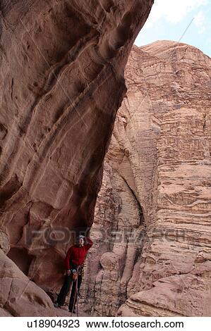 Woman rappelling on rock face, Wadi Rum, Jordan View Large Photo Image Stock Image - Woman rappelling on rock face, Wadi Rum, Jordan. Fotosearch