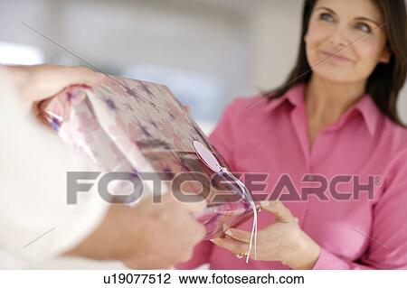 Woman recieving a gift View Large Photo Image Stock Image - Woman recieving a gift. Fotosearch