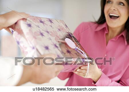 Stock Photography - Woman recieving a gift. Fotosearch