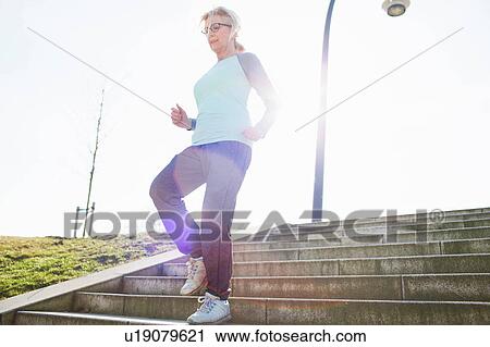 Woman running down steps View Large Photo Image Stock Image - Woman running down steps. Fotosearch