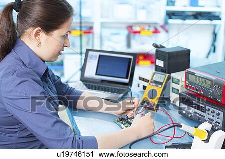 Woman soldering a printed circuit board View Large Photo Image Stock Image - Woman soldering a printed circuit board. Fotosearch