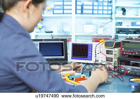 Woman soldering a printed circuit board View Large Photo Image Stock Image - Woman soldering a printed circuit board. Fotosearch