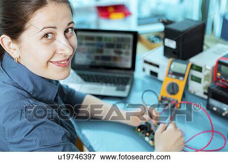 Woman soldering a printed circuit board View Large Photo Image Stock Photo - Woman soldering a printed circuit board. Fotosearch