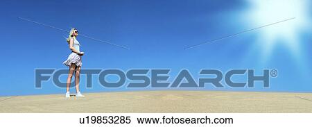 Stock Photography - Woman standing on sand. Fotosearch