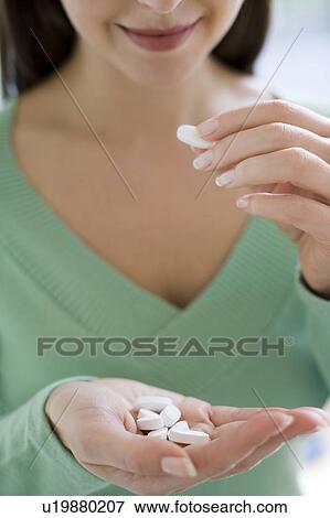 Stock Photo - Woman taking medication. Fotosearch