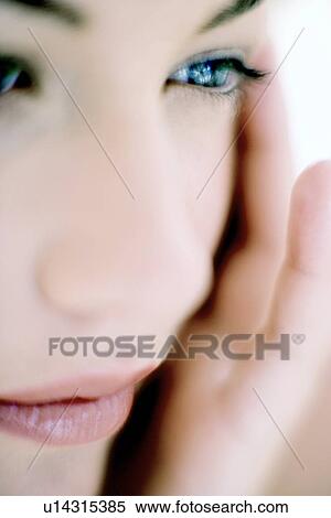 Stock Photography - Woman touching her face. Fotosearch