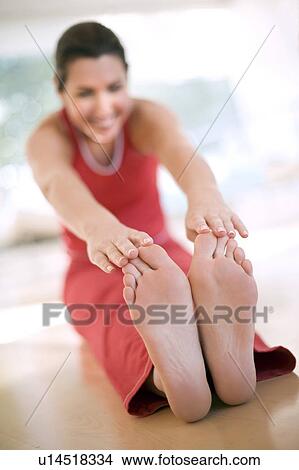 Woman touching her toes View Large Photo Image Picture - Woman touching her toes. Fotosearch