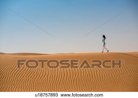 Woman tourist walking on desert dune, Dubai, United Arab Emirates View Large Photo Image Stock Image - Woman tourist walking on desert dune, Dubai, United Arab Emirates. Fotosearch