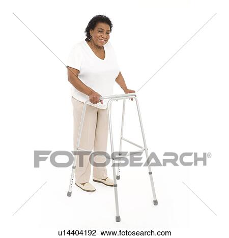 Stock Image - Woman using a walking aid. Fotosearch