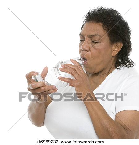 Woman using an asthma spacer View Large Photo Image Stock Image - Woman using an asthma spacer. Fotosearch