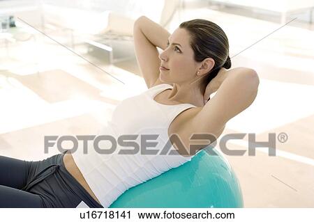 Woman using exercise ball View Large Photo Image Stock Image - Woman using exercise ball. Fotosearch