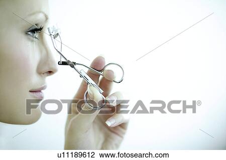 Woman using eyelash curlers View Large Photo Image Stock Image - Woman using eyelash curlers. Fotosearch