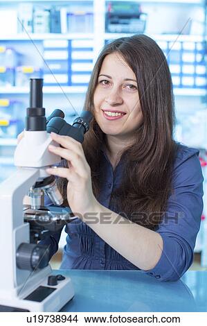 Woman using microscope View Large Photo Image Picture - Woman using microscope. Fotosearch