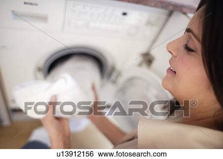 Stock Photograph - Woman washing clothes. Fotosearch