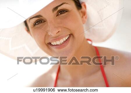 Stock Photograph - Woman wearing a sunhat. Fotosearch