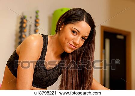 Woman wearing crop top looking at camera smiling View Large Photo Image Stock Image - Woman wearing crop top looking at camera smiling. Fotosearch