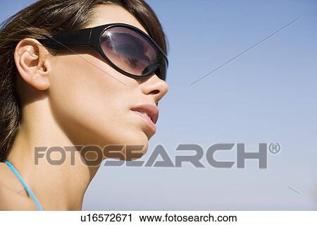 Stock Image - Woman wearing sunglasses. Fotosearch