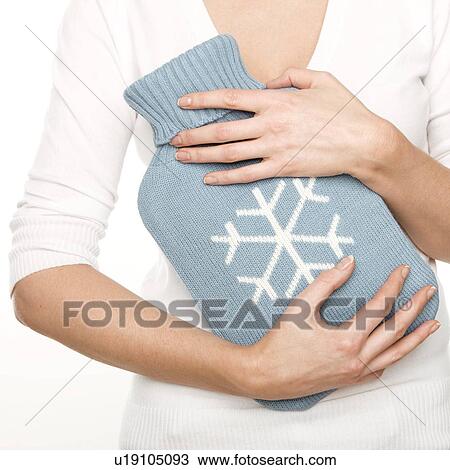 Woman with a hot water bottle View Large Photo Image Stock Image - Woman with a hot water bottle. Fotosearch