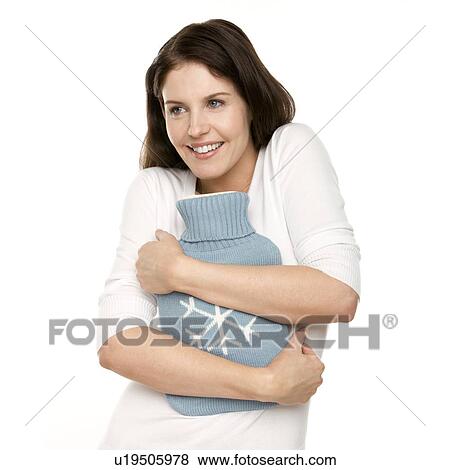 Stock Photo - Woman with a hot water bottle. Fotosearch