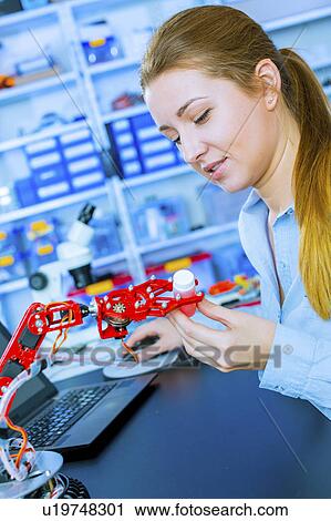 Woman working on a robotic arm View Large Photo Image Stock Image - Woman working on a robotic arm. Fotosearch