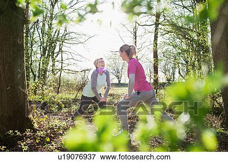 Women face to face in forest hands on knee lunging View Large Photo Image Stock Photo - Women face to face in forest hands on knee lunging. Fotosearch