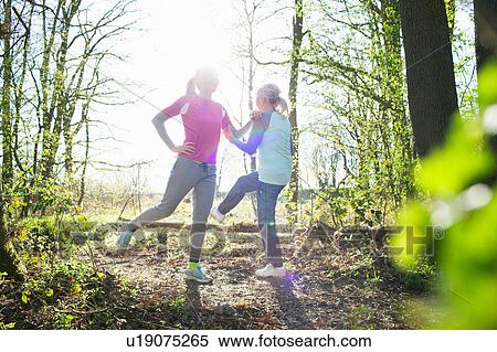 Women in forest face to face legs raised stretching View Large Photo Image Stock Photography - Women in forest face to face legs raised stretching. Fotosearch