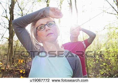 Women in forest hand on forehead looking exhausted View Large Photo Image Stock Image - Women in forest hand on forehead looking exhausted. Fotosearch