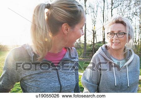 Stock Photograph - Women wearing sports clothing face to face talking. Fotosearch
