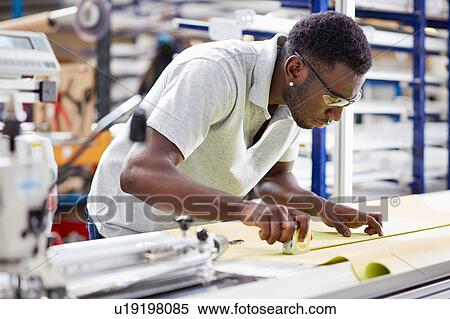 Worker assembling roller blind on production line in factory View Large Photo Image Stock Photography - Worker assembling roller blind on production line in factory. Fotosearch