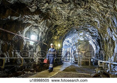 Stock Photography - Worker in tunnel in hydroelectric power station. Fotosearch