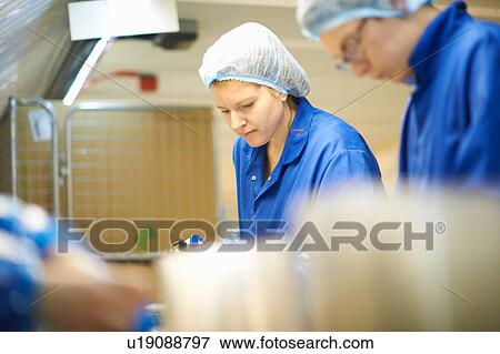 Worker on production line wearing hair net View Large Photo Image Stock Photo - Worker on production line wearing hair net. Fotosearch