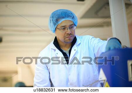 Worker preparing for cultivation of micro greens in underground tunnel nursery, London, UK View Large Photo Image Stock Image - Worker preparing for cultivation of micro greens in underground tunnel nursery, London, UK. Fotosearch
