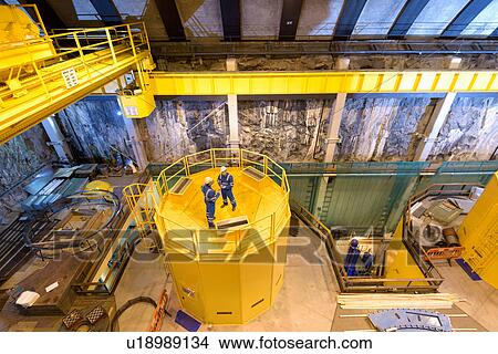Picture - Workers in generating hall in hydroelectric power station, high angle view. Fotosearch