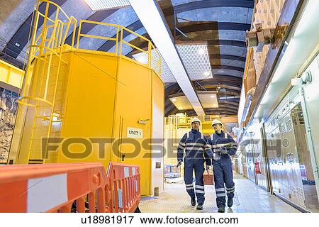 Workers in generating hall in hydroelectric power station View Large Photo Image Stock Photo - Workers in generating hall in hydroelectric power station. Fotosearch