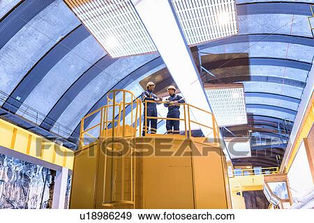 Workers in generating hall in hydroelectric power station View Large Photo Image Stock Photo - Workers in generating hall in hydroelectric power station. Fotosearch