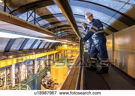 Workers in generating hall in hydroelectric power station View Large Photo Image Stock Photo - Workers in generating hall in hydroelectric power station. Fotosearch