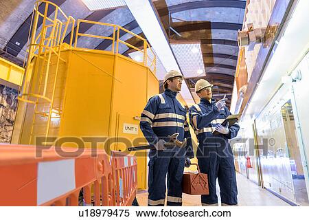 Workers in generating hall in hydroelectric power station View Large Photo Image Stock Photography - Workers in generating hall in hydroelectric power station. Fotosearch