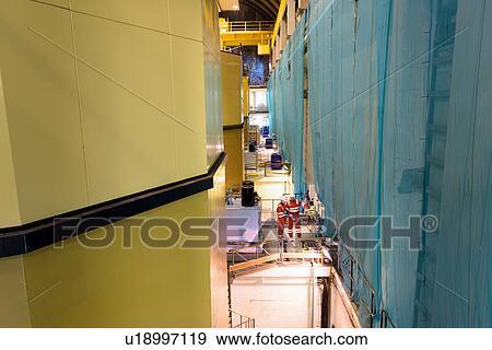 Stock Photo - Workers in hydroelectric power station. Fotosearch
